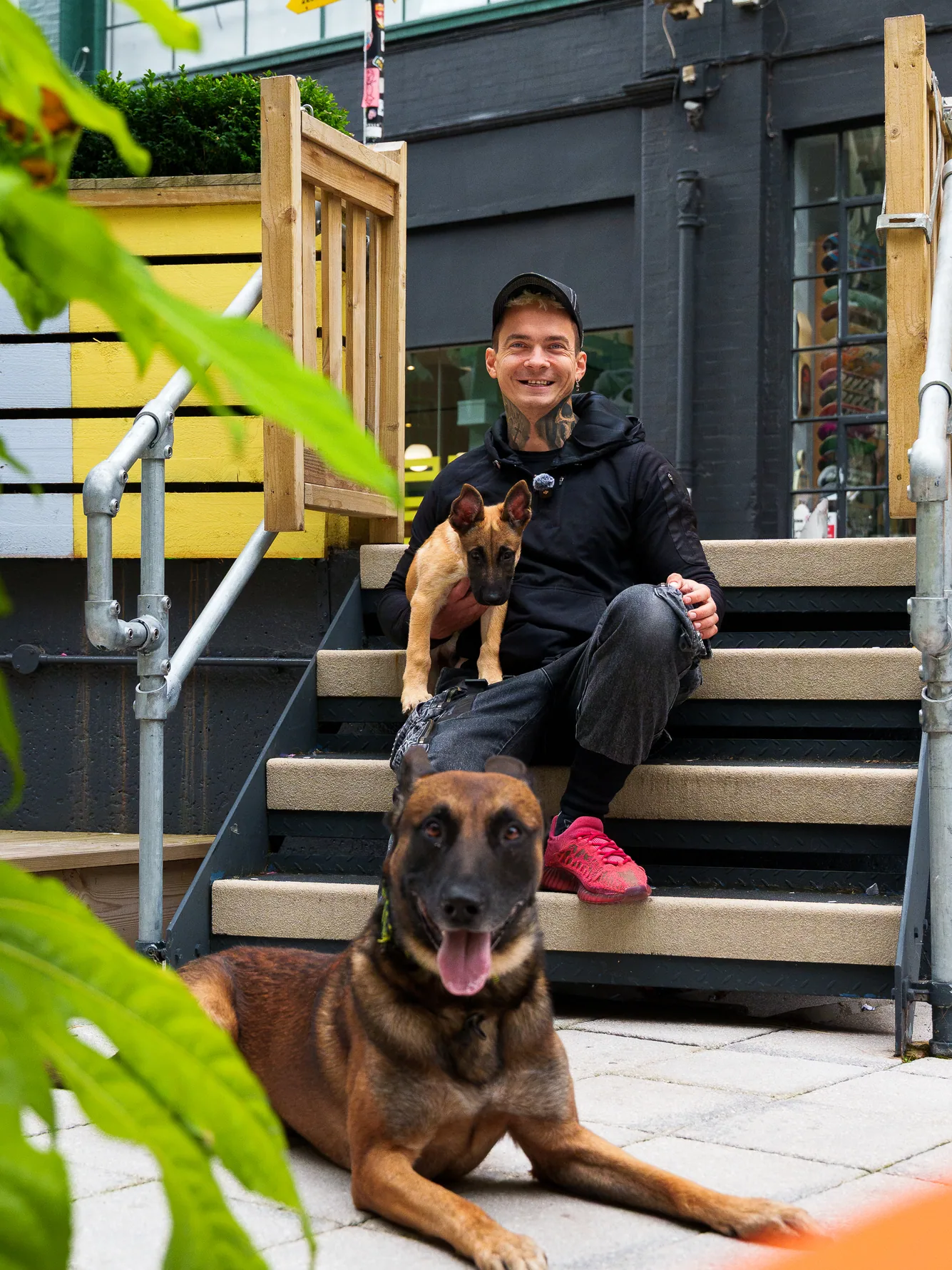 Andrejus posing with his two working dogs on Birmingham city centre steps