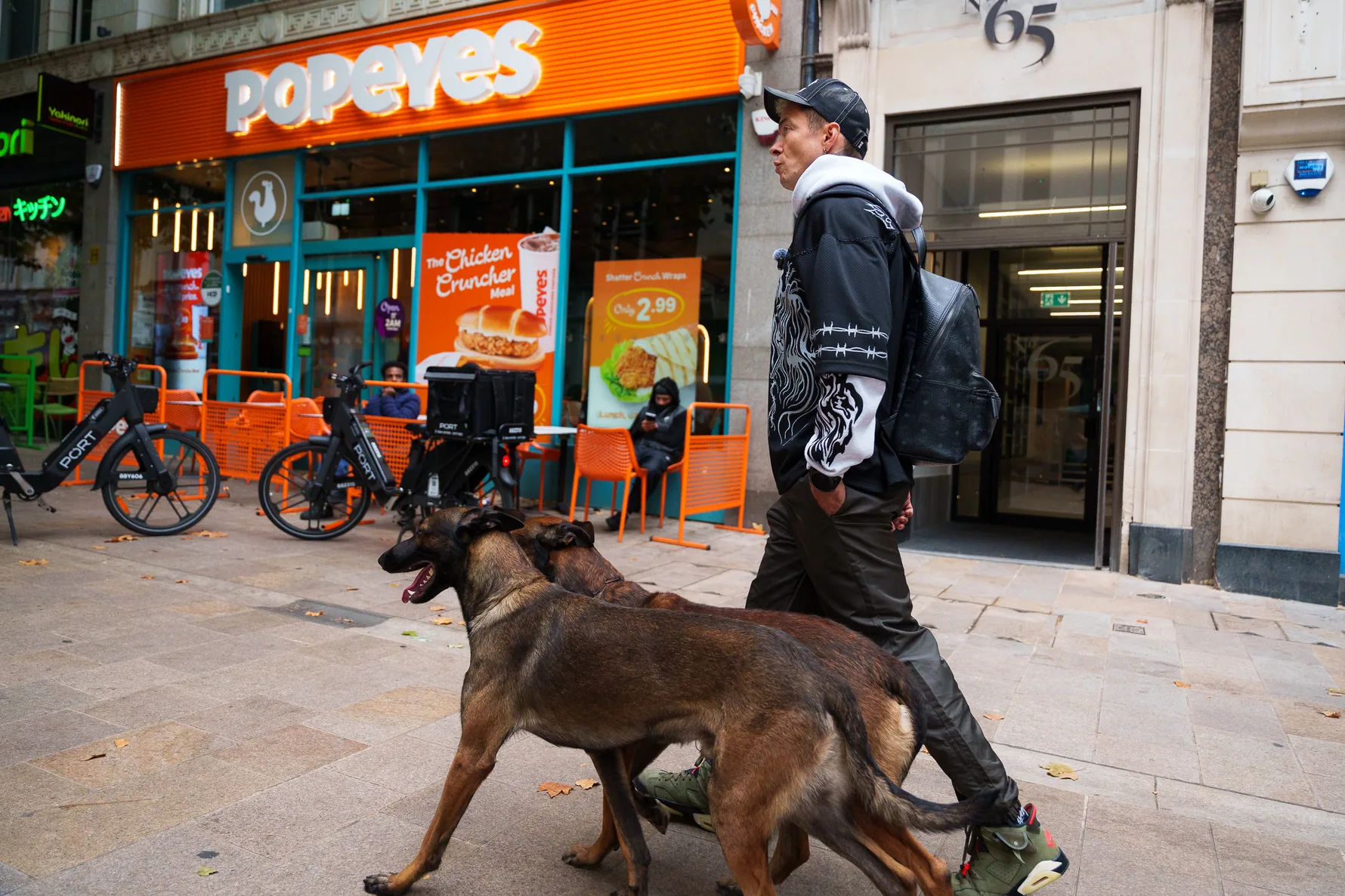Two working dogs walking through Birmingham shopping streets