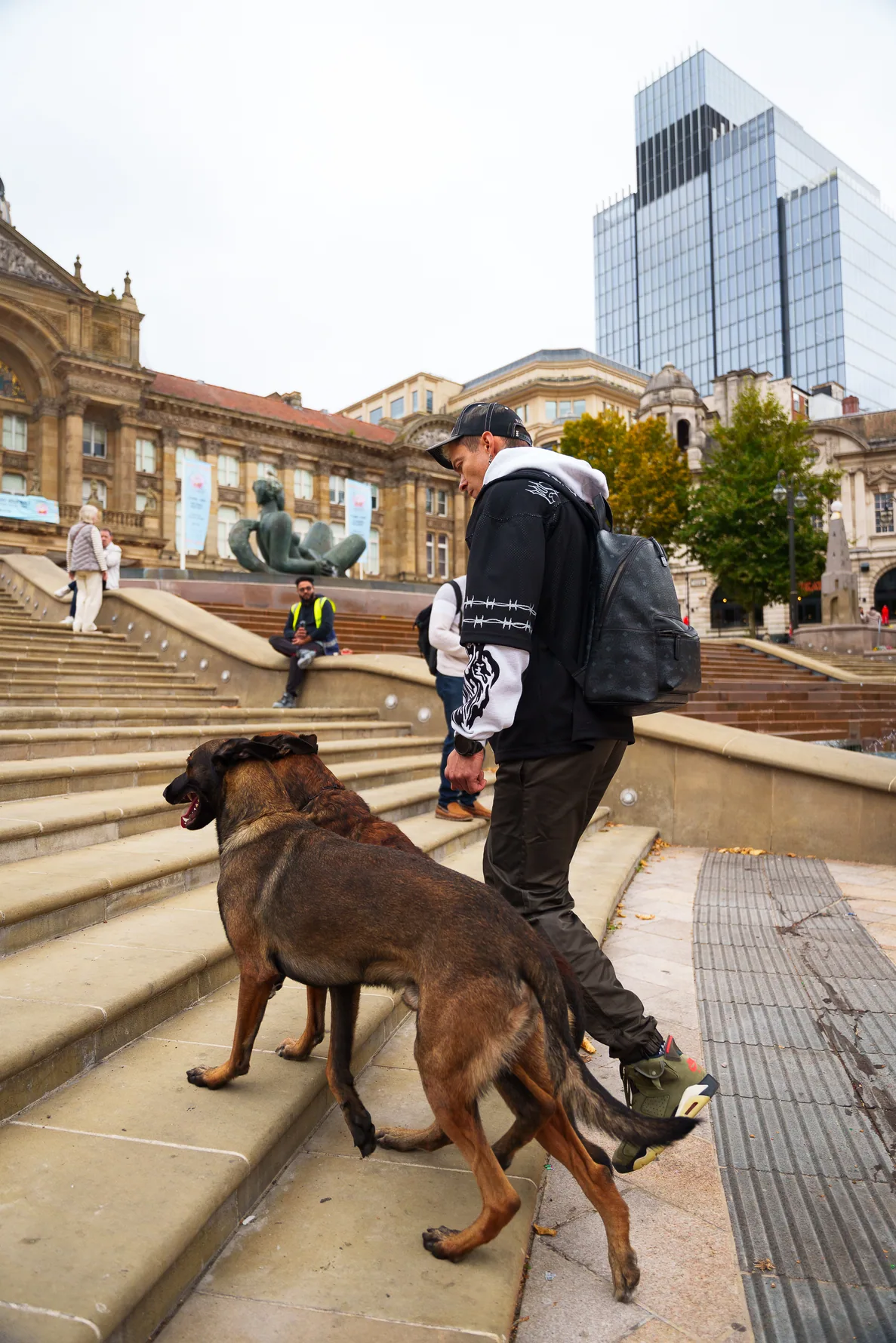 Working dog keeping close to Andrejus during an urban walk