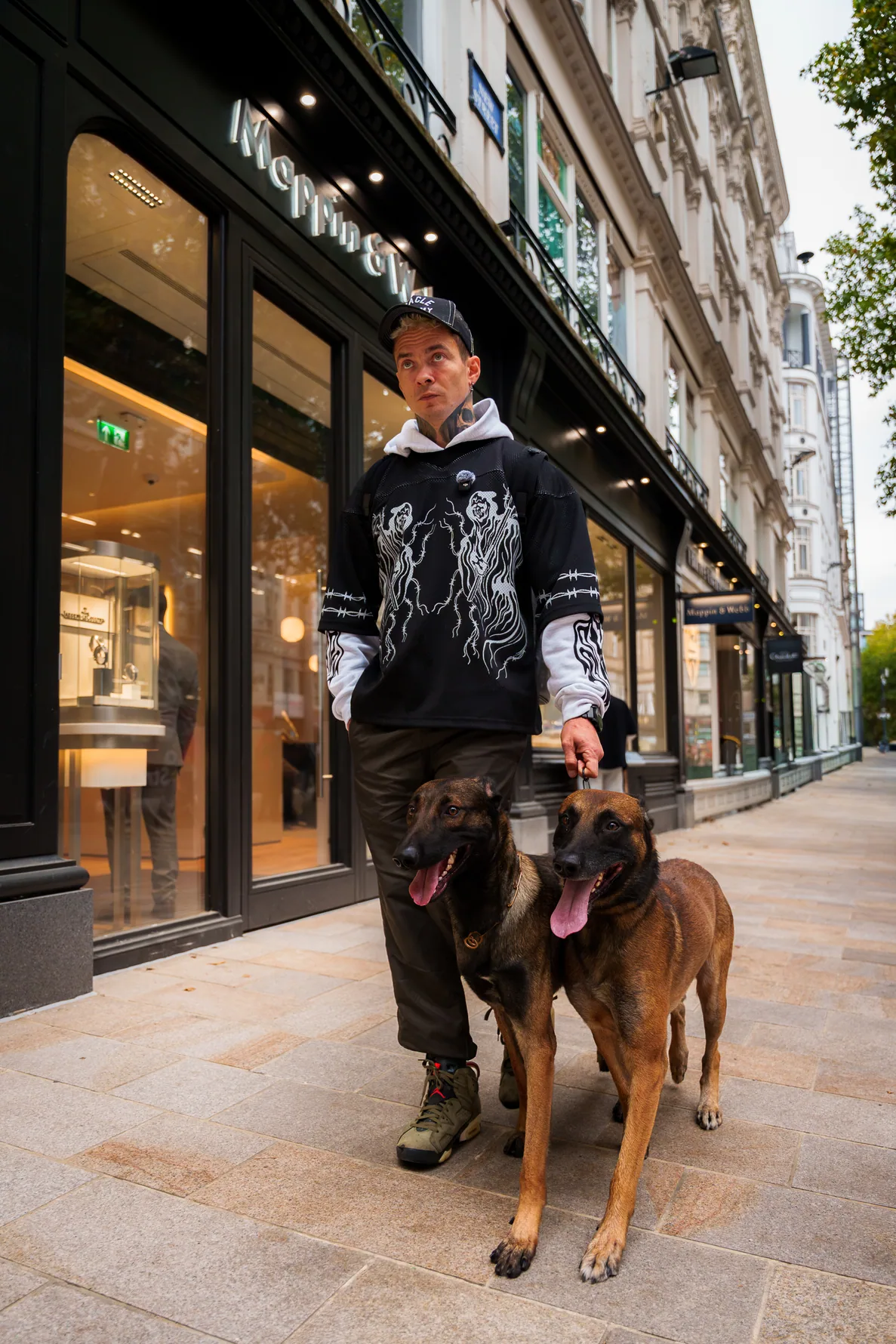 Andrejus and his working dogs beside shopfronts on a city street