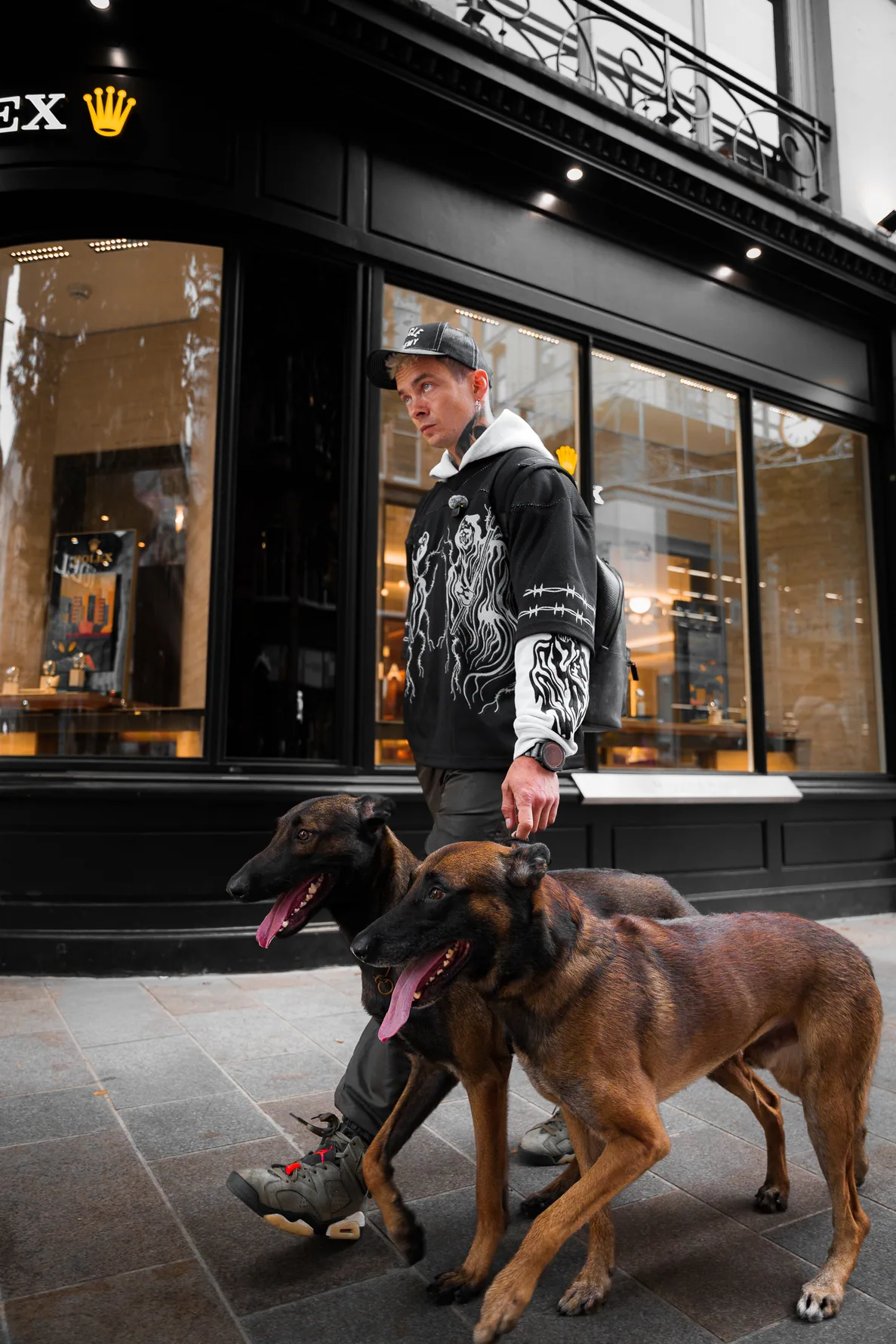 Two working dogs moving together during a pavement training exercise