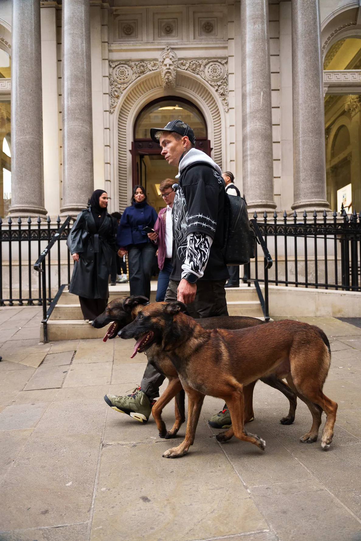 Andrejus walking working dogs through a busy city centre