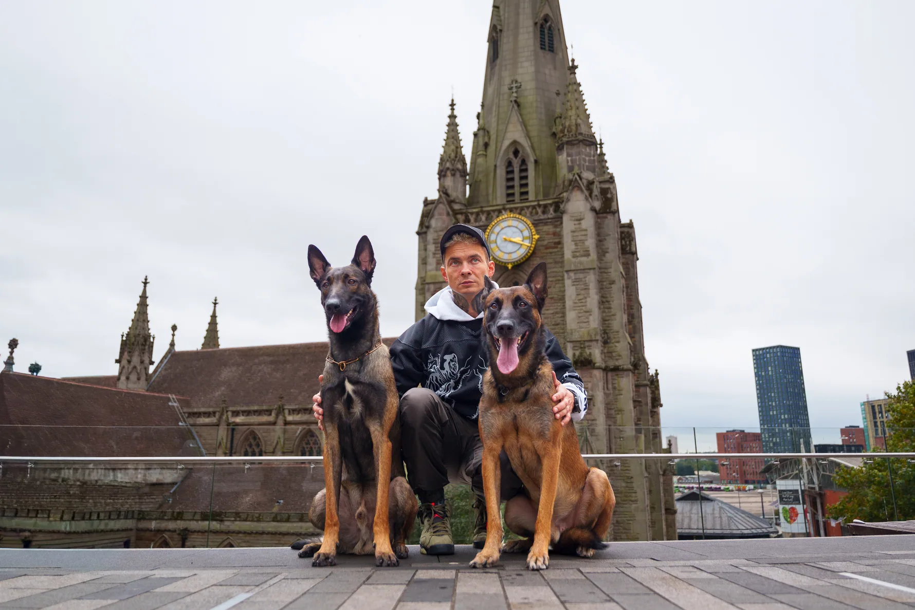 Andrejus with his working dogs in a Birmingham city centre skyline setting