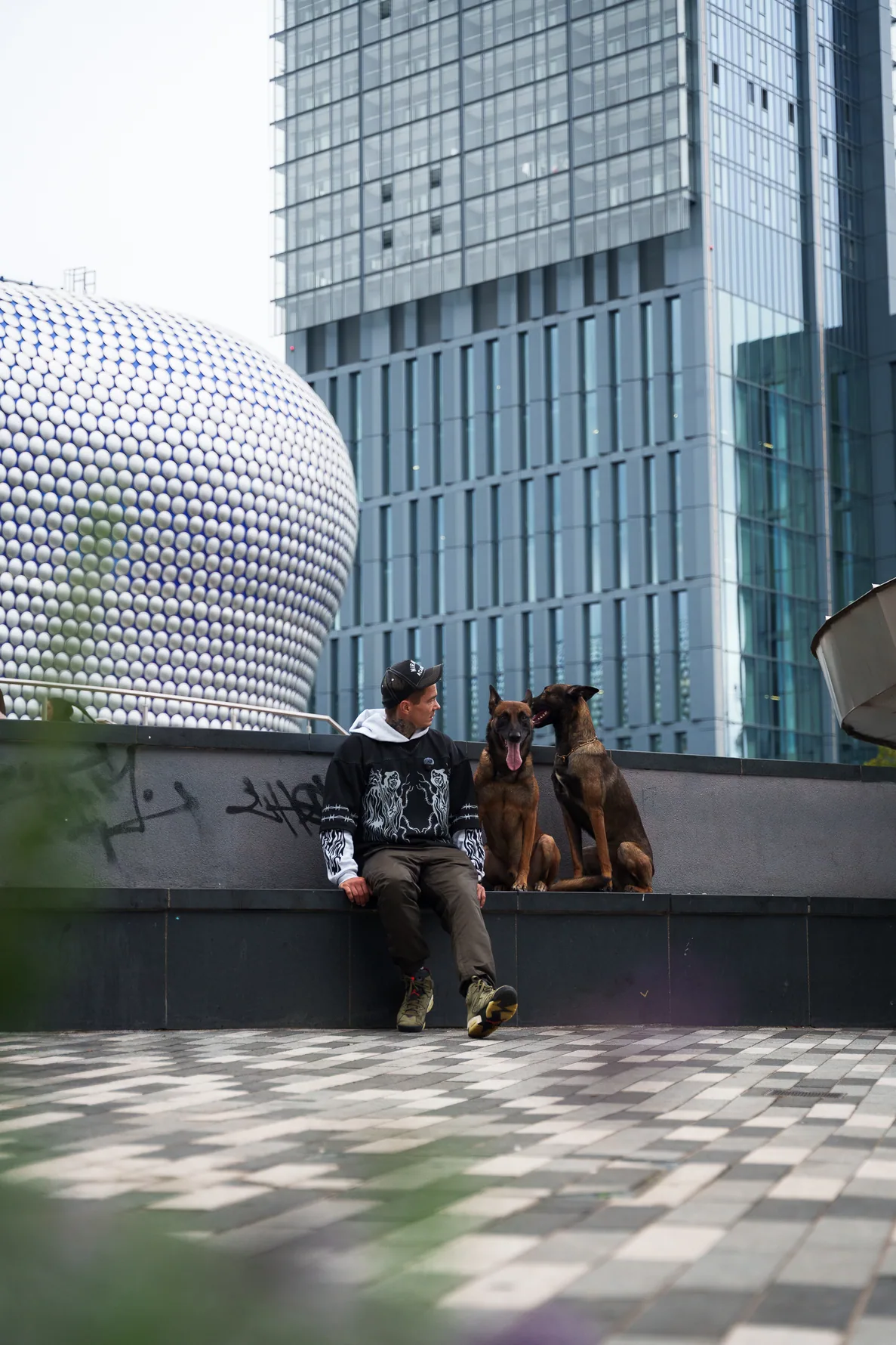 Andrejus and working dogs near modern architecture in Birmingham
