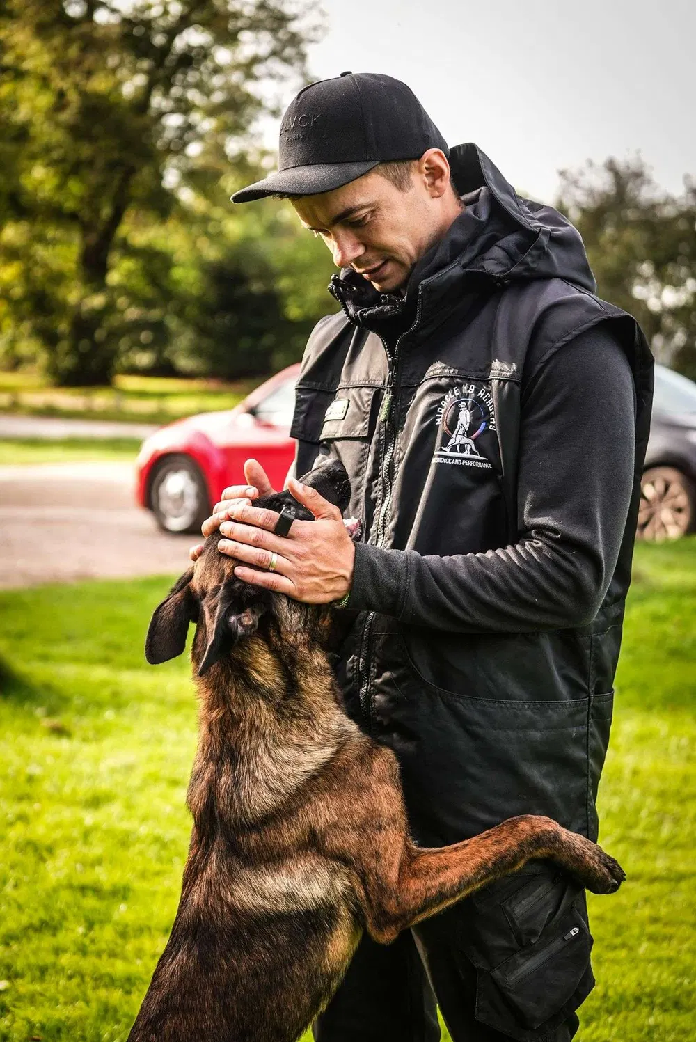 Andrejus rewarding a working dog during a Miracle K9 Academy session