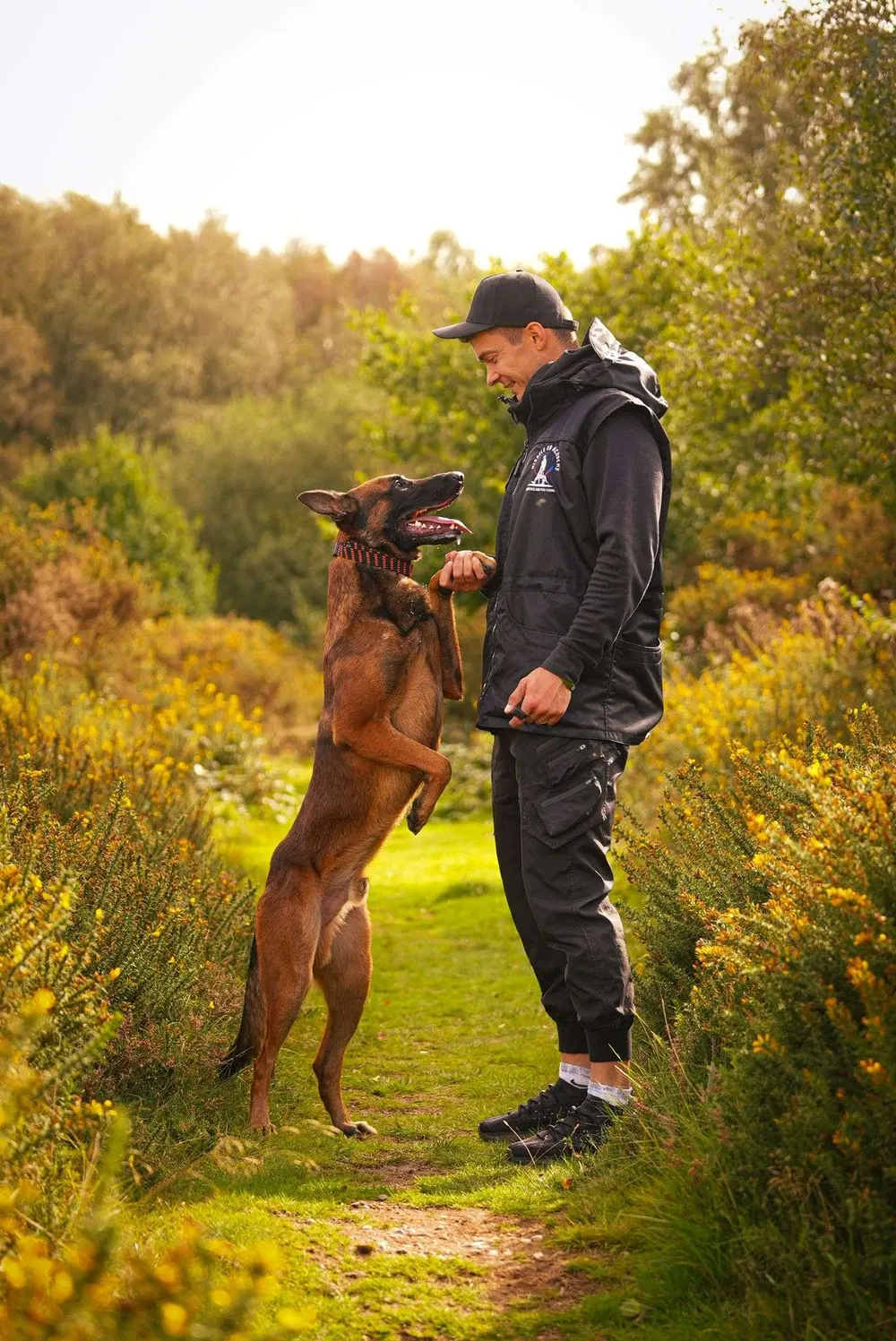 Handler and working dog practising engagement outdoors